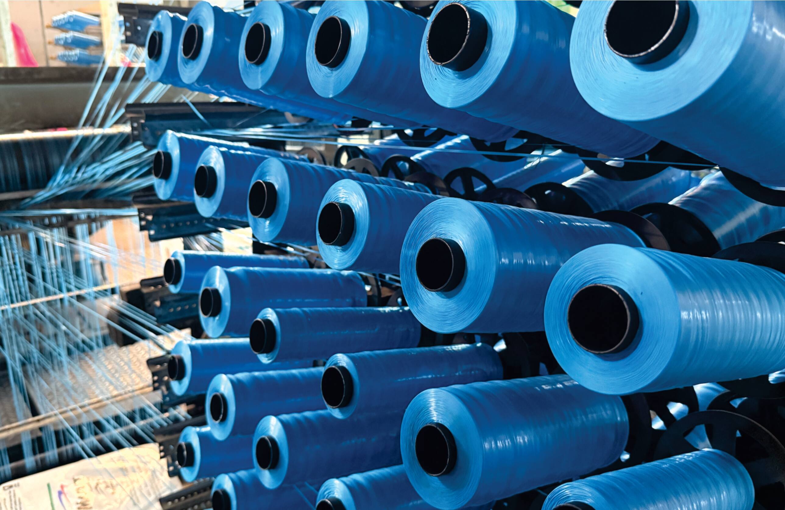 WPP (Woven Polypropylene) leno loom machines for producing open-mesh bags and fabrics at Dambulla Lanka Polysacks Factory.